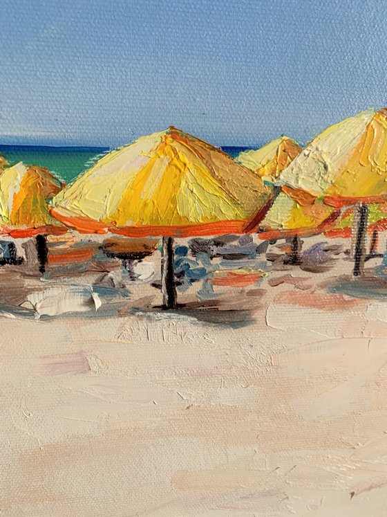 At the beach. Yellow parasols.