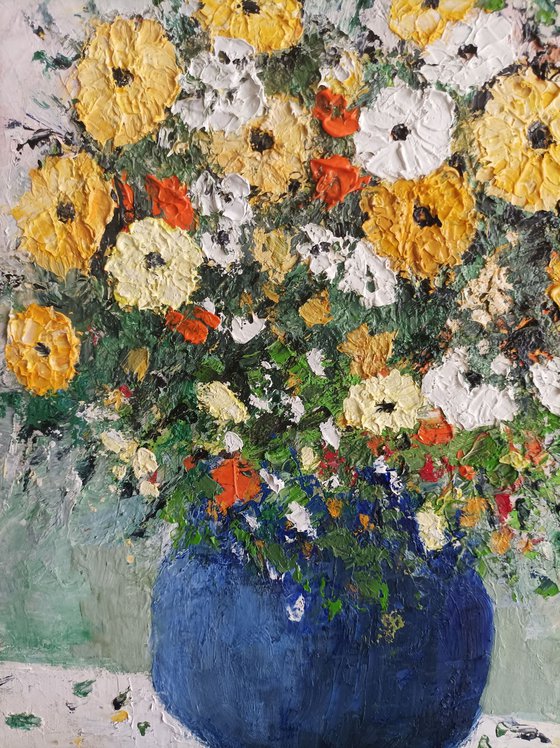 Yellow flowers in a blue vase