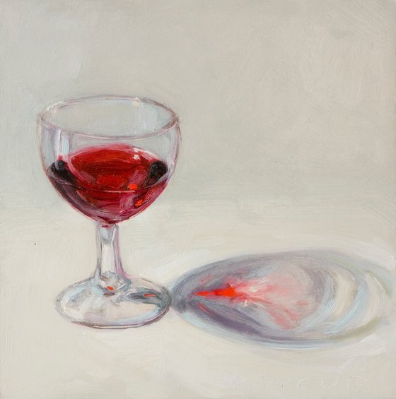 glass of red wine on white