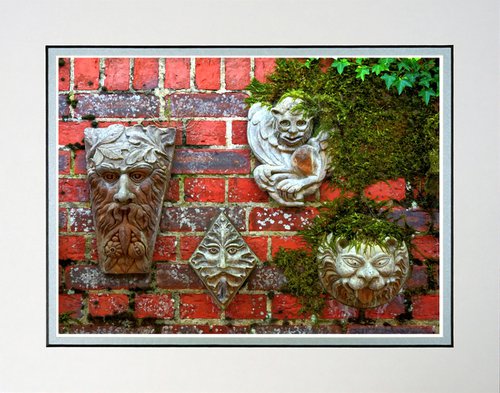 Faces on a wall sculpture by Robin Clarke