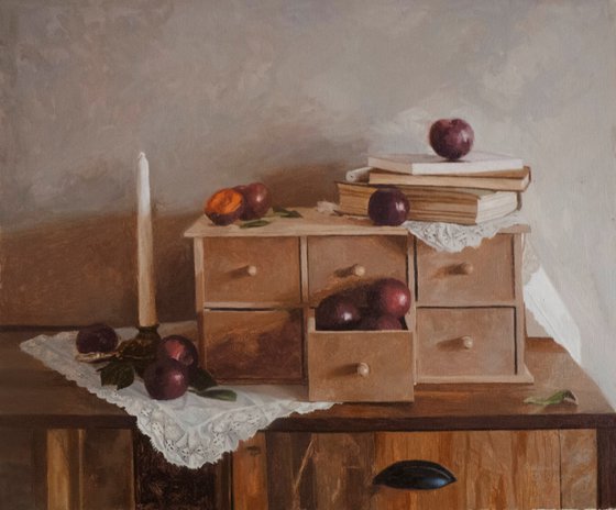 Plums, candle and books