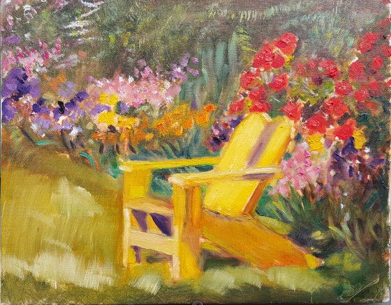 Yellow chair in riot of flowers