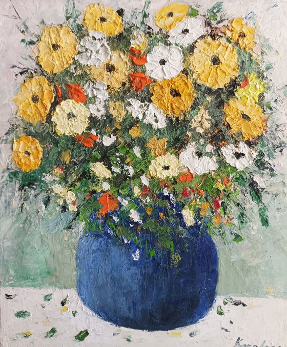 Yellow flowers in a blue vase