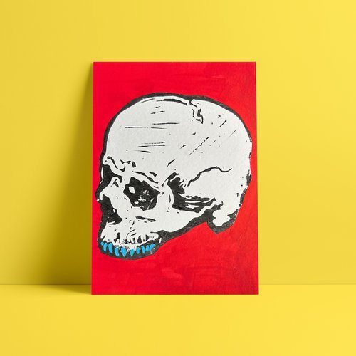 Teeny tiny skull lino print painted red by Mr. E