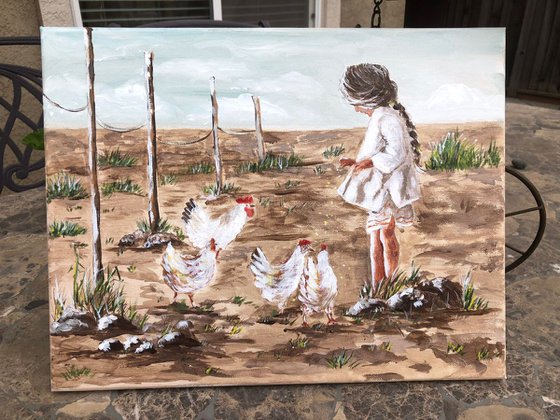 Girl feeding chickens