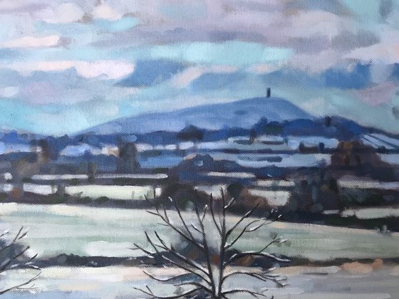 Snowy Skies Over Glastonbury Tor