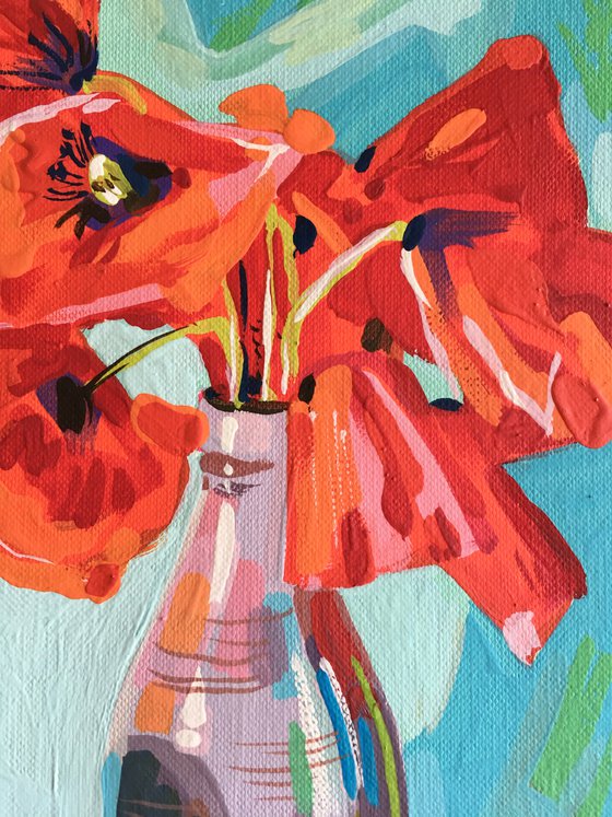 Red poppies in vase and pear