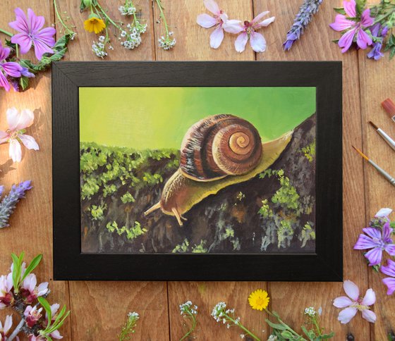 Cute snail on a mossy branch