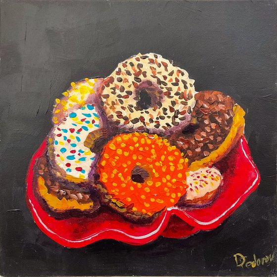 Colourful donuts in red dish