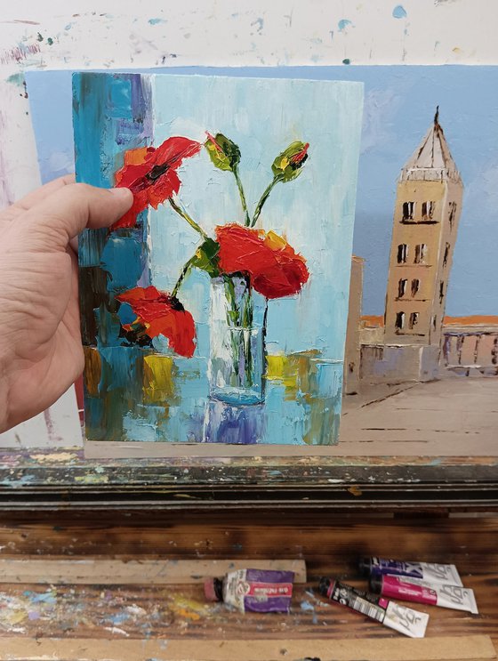 Red poppy in glass