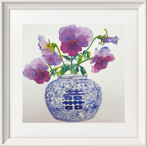 Purple pansies in a blue & white vase