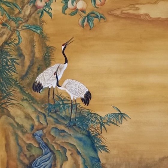 Cranes Under A Peach Tree At The Top Of A Waterfall