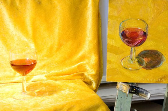 glass of red wine on yellow