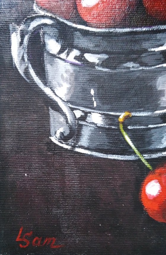 Red cherries in a metal cup