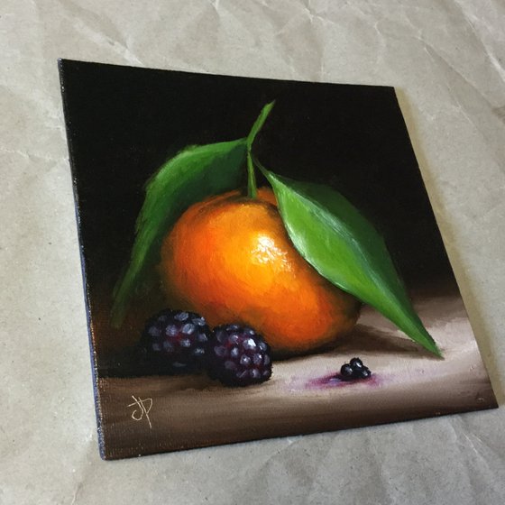 Small Clementine with blackberries still life