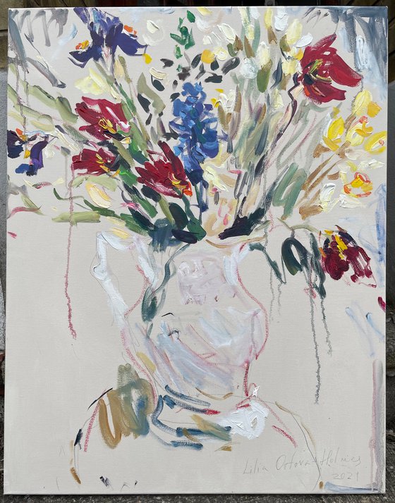 Spring flowers in a white jug.