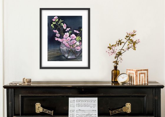 Still life with cherry blossoms in a vase.