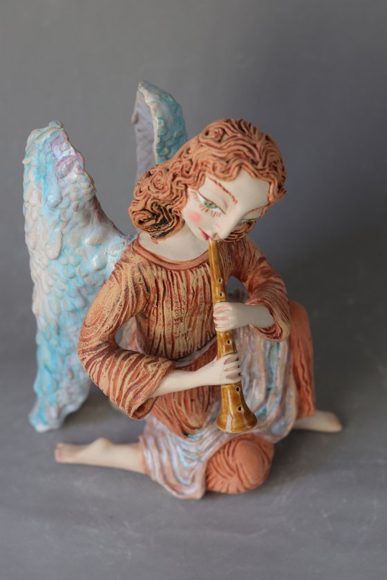 Sitting Angel with a flute. Ceramic OOAK sculpture.