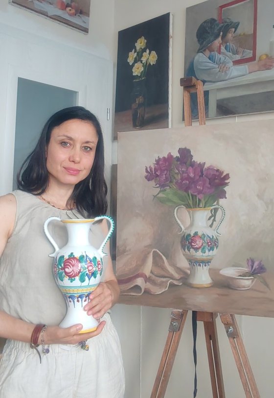 Purple flowers in a colorful jug