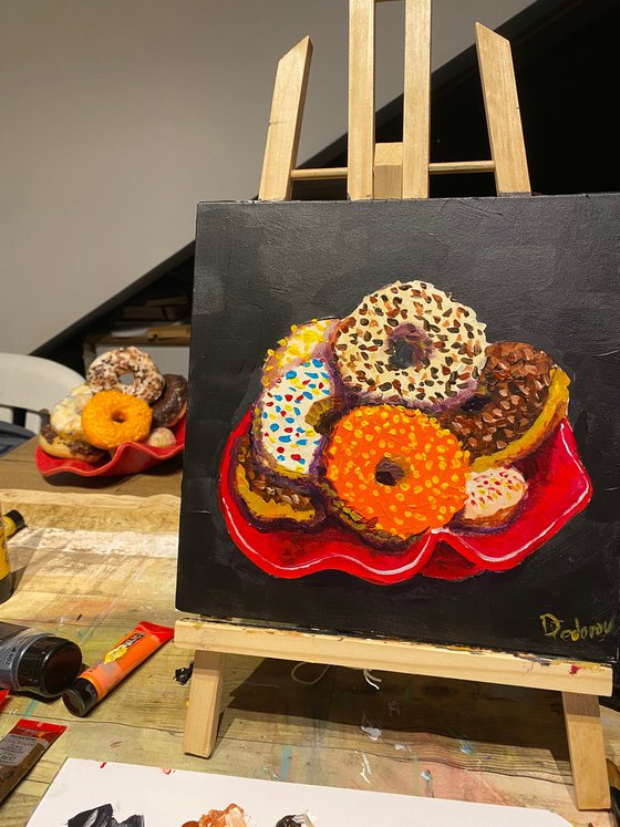 Colourful donuts in red dish