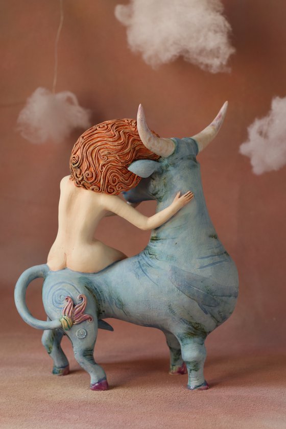 Riding your dreams. Girl on a blue ox