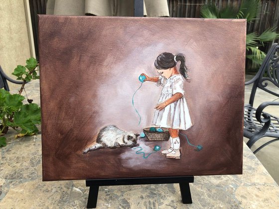 Girl playing with cat