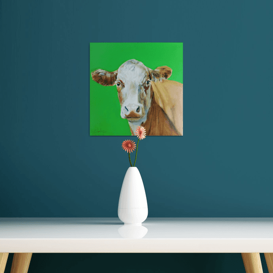 Portrait of a cow in green