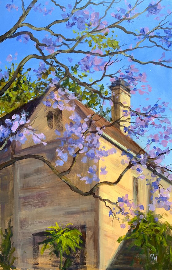 Yellow stone house with jacaranda