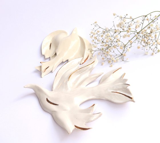 Bird of peace .Haven bird .Wall art. White ceramic bird with gold decoration .Hanging on the wall sculpture.