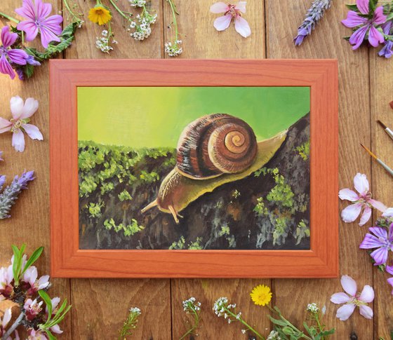 Cute snail on a mossy branch