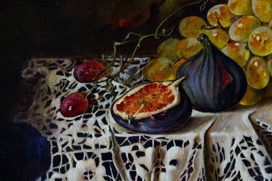 Still life with grapes and figs on a lace tablecloth