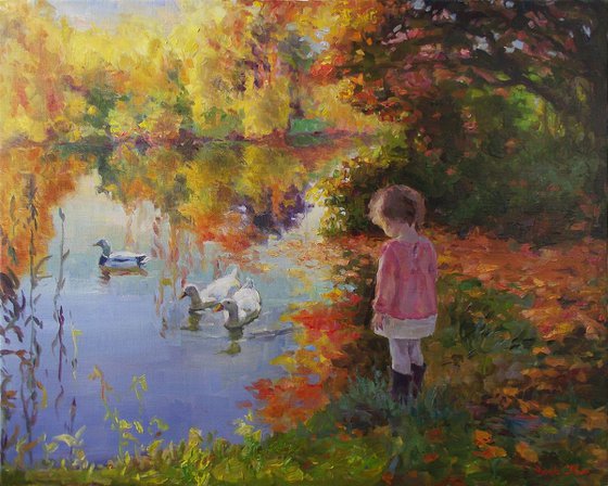 Girl and ducks, golden autumn