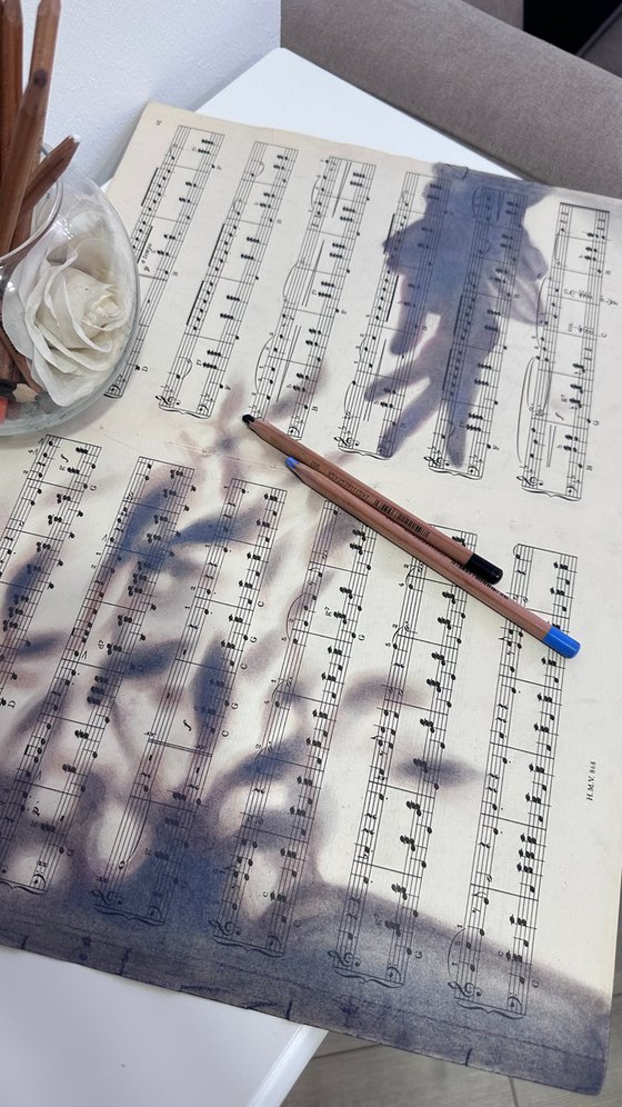 Silhouette Hand And Leaves on Music Sheet