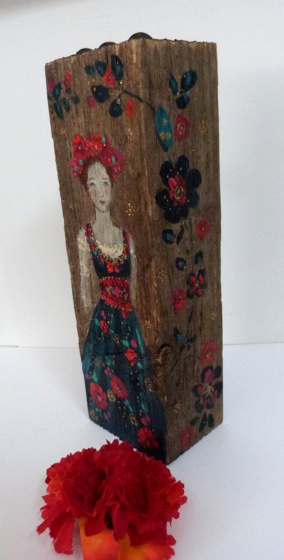 Totem sculpture Slavic woman on painted wood.