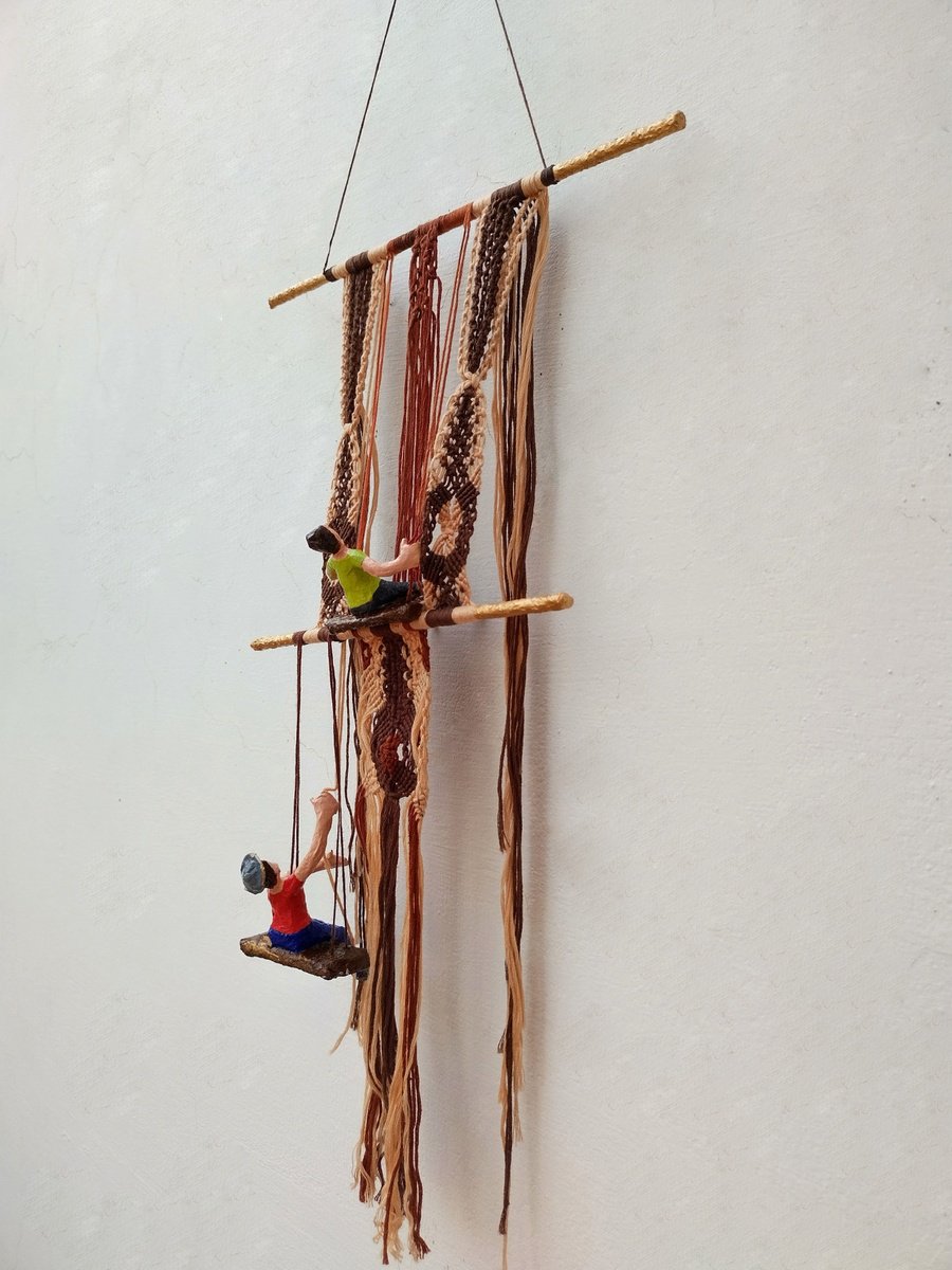 Figures working on the macrame wall hanging Mixed-media sculpture