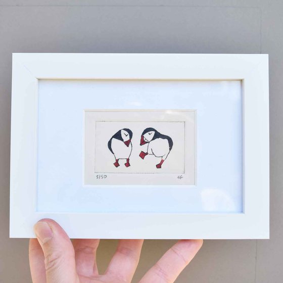 Small framed two puffins (one dancing, one coy)