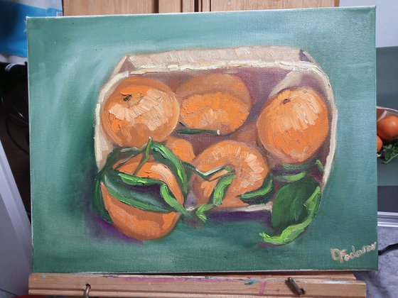 Still life with tangerines in a wooden basket