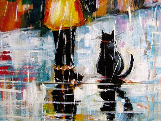 Girl with cat in the rain