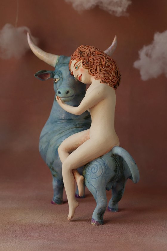 Riding your dreams. Girl on a blue ox