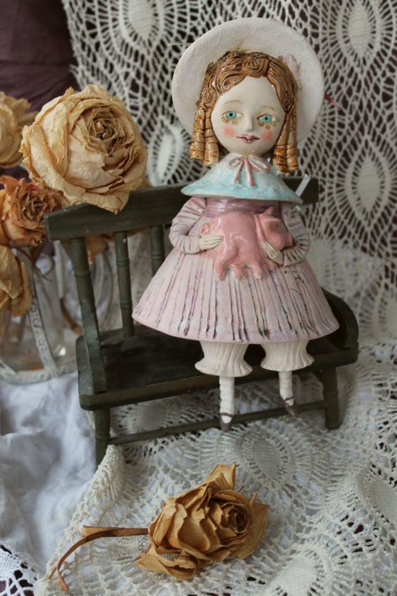 Vintage dressed girl holding a pig. Mini sculpture, unique ceramic bell doll.