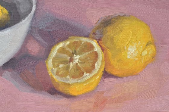 Lemons and white bowl, pink background