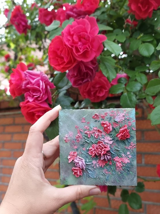 Miniature pink roses. A small floral botanical relief. 3d painting of spring flowers with ceramic petals.