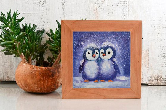 Two penguins painting