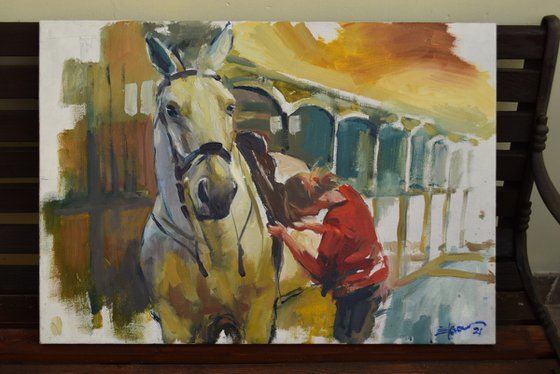 girl saddling horse
