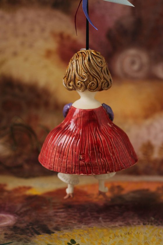 Little girl in red dress. Hanging sculpture, bell doll by Elya Yalonetski