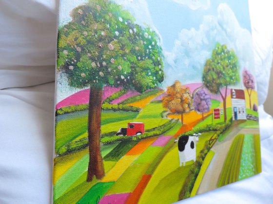 Folk art cow in a field