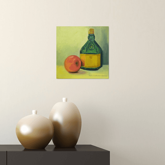 Apple and green bottle still life