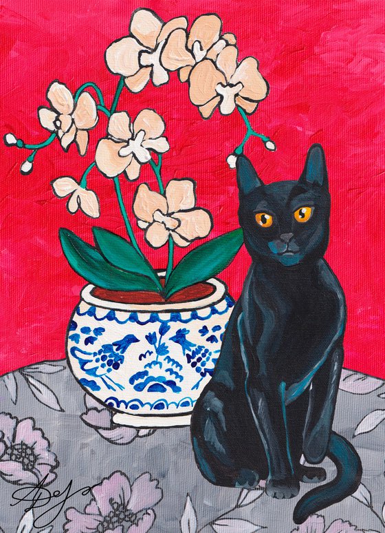 Black cat on the red background of an orchid.