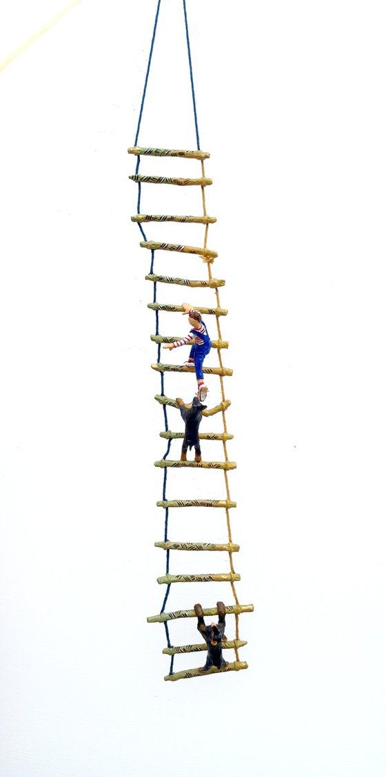 Two Dobermans on ladder