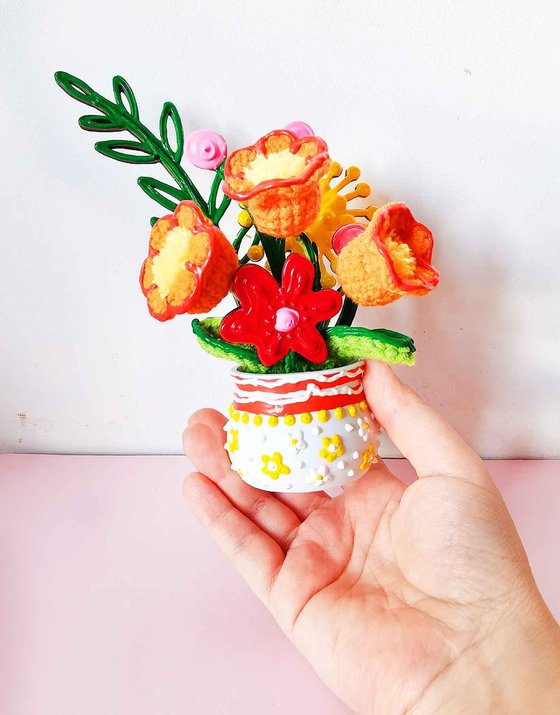 Orange crochet flowers in vase